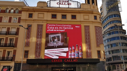 Una de las participantes en la acción posa en el photocall a la vez que se ve en la pantalla